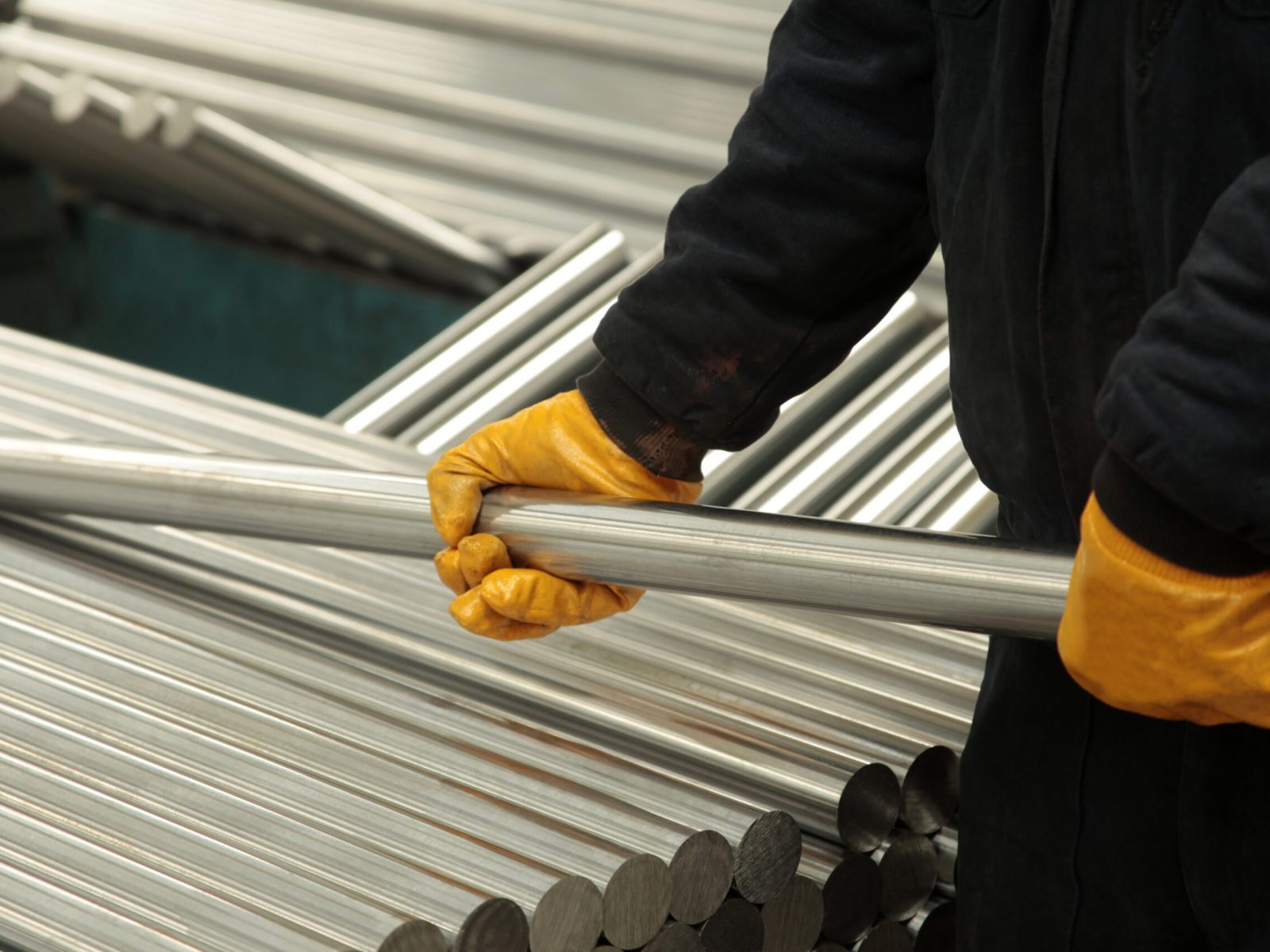 New steel pipes. A worker at the factory.